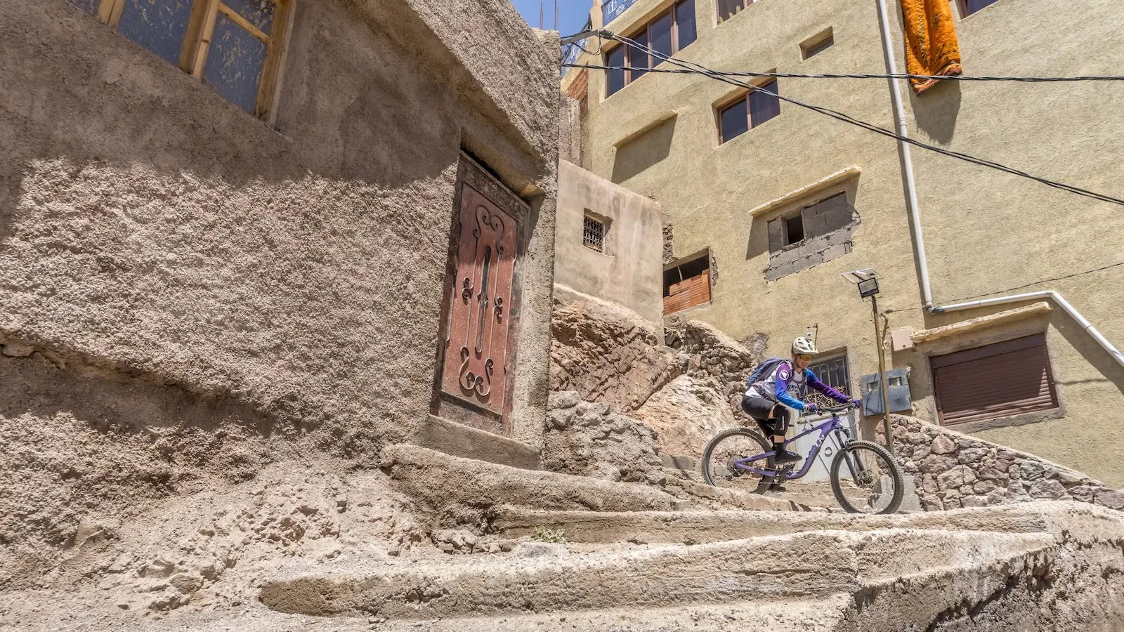 Female mountain biker coming round tight corner in Morocco