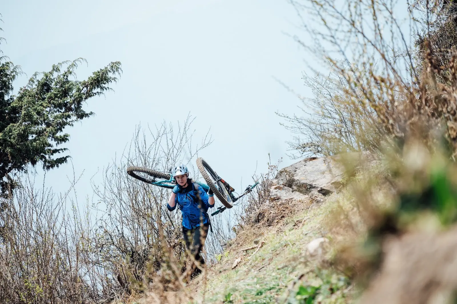 Mountain biker carrying their bike in Bhutan