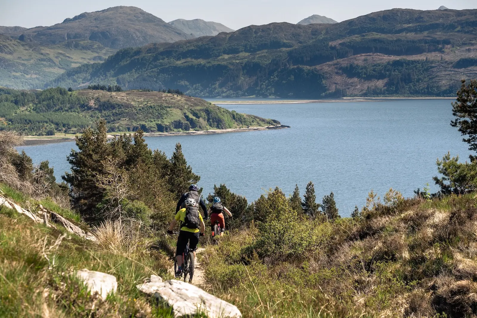 Riding a singletrack descent with views over the sea
