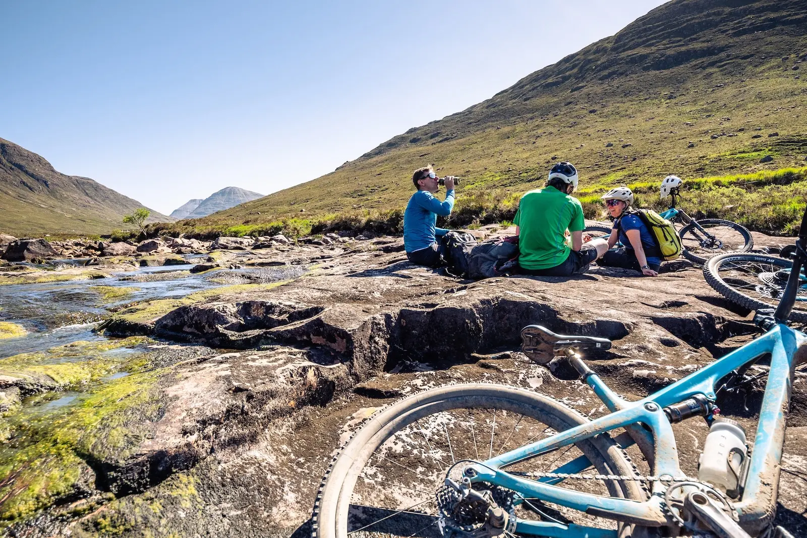 Taking a break from biking by a stream in Scotland