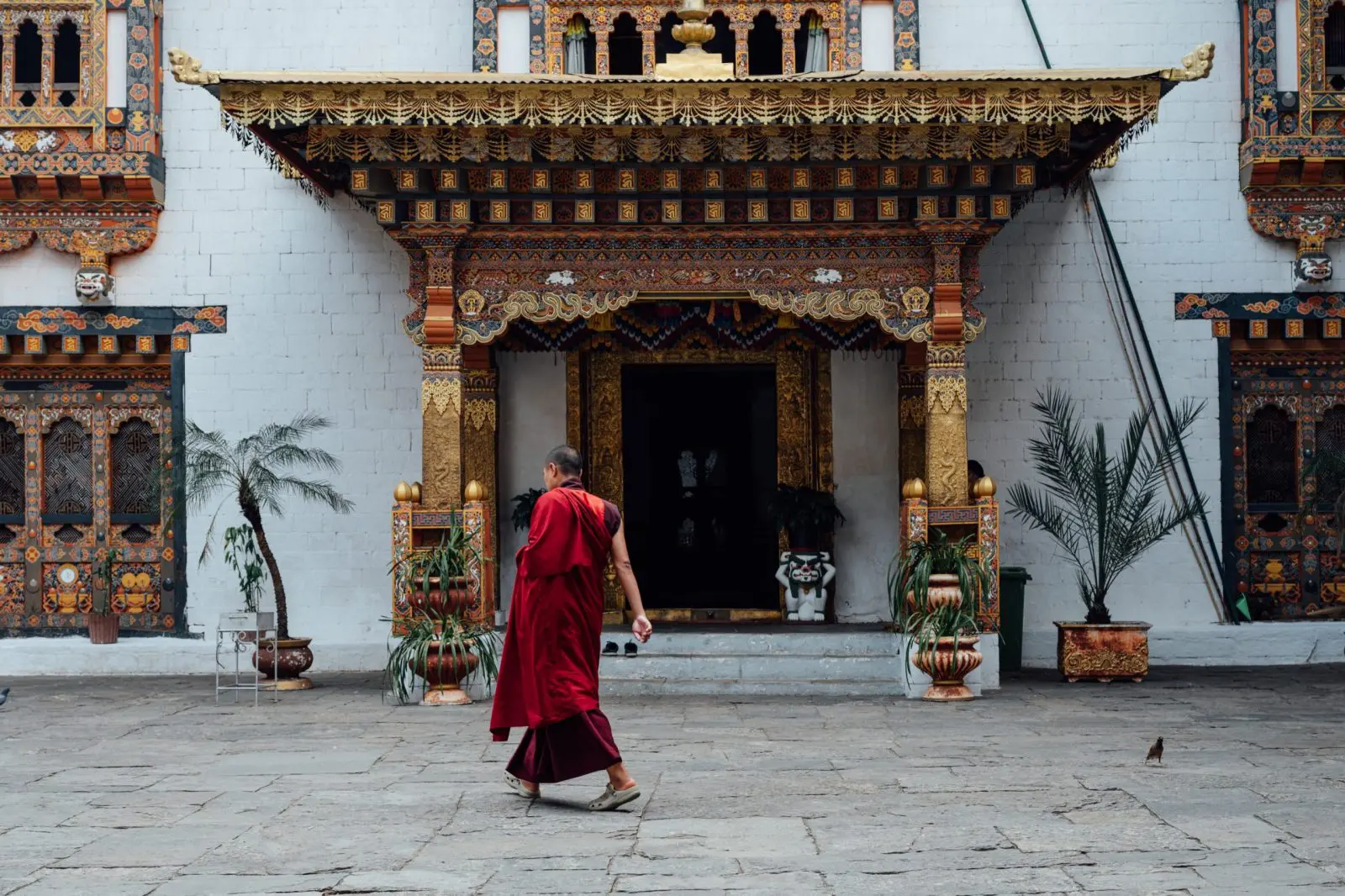 Monk walking past Dzong