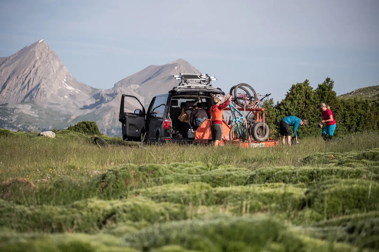 Mountain bikers loading bikes onto a trailer in the Spanish Pyrenees