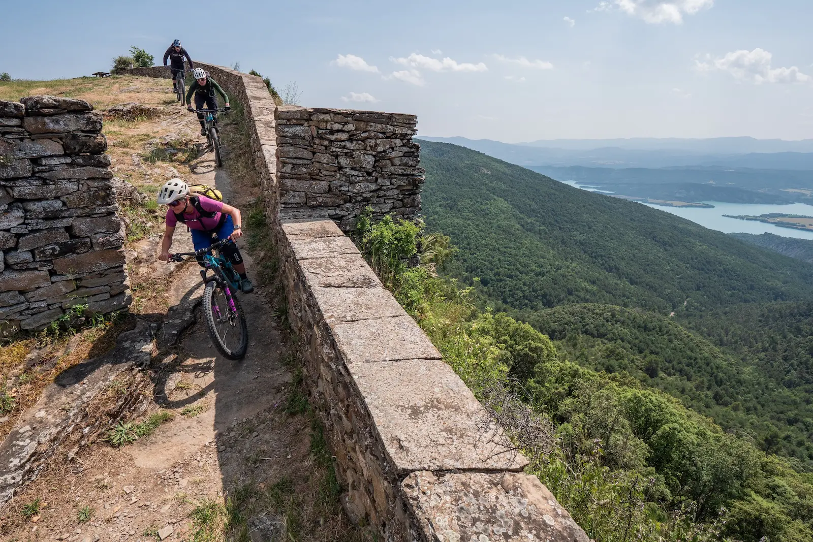 Mountain bikers, lakes and ancient walls in the Pyrenees