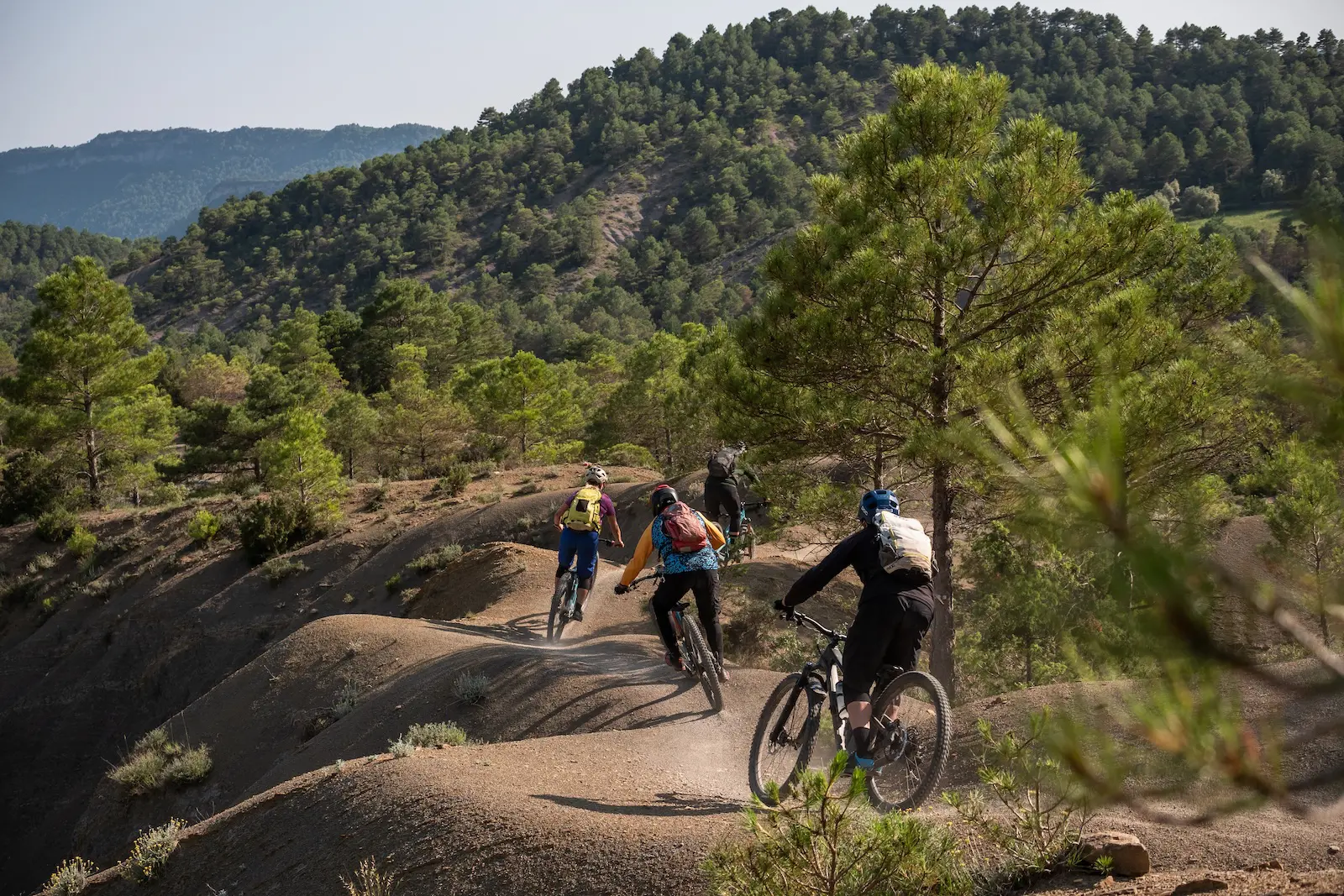Four mountain bikers riding the trails of the Spanish Pyrenees