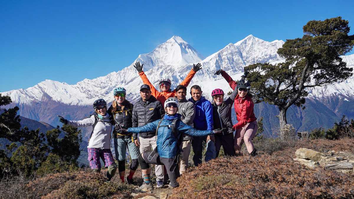 Women mountain biking in Nepal with local guides
